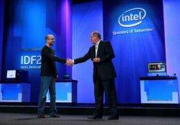 Intel CEO Paul Otellini (R) shakes hands with Google Senior VP of Mobile Andy Rubin