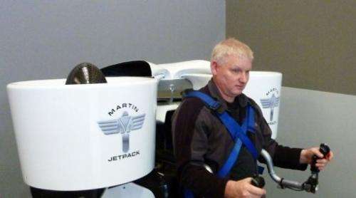 Jetpack inventor Glenn Martin sits with his creation strapped to his back in Christchurch