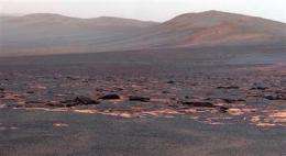 Mars rover Opportunity examining rocks at new site (AP)