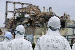 Members of a Japanese government panel inspect the damage at the Fukushima nuclear power plant