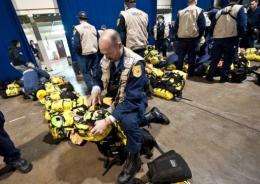 Members of the Fairfax County Search and Rescue team prepare their equipment at Misawa Air Base, in northern Japan