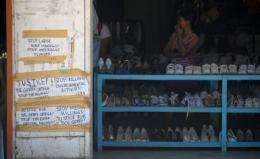 Messages seeking justice are posted at the clothing shop where environment activist Gerry Ortega was shot in Palawan