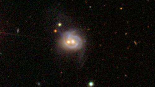 Nearby galaxy boasts 2 monster black holes, both active