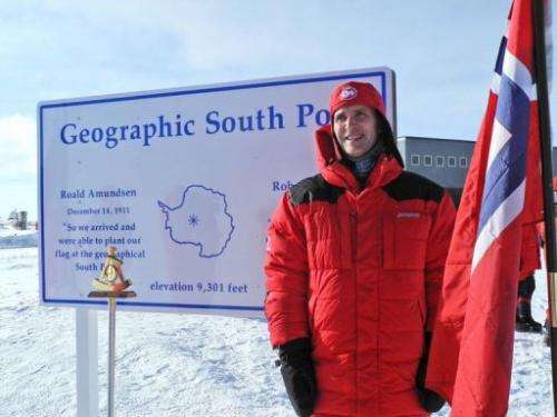Norwegian Prime Minister Jens Stoltenberg stands at the geographic South Pole