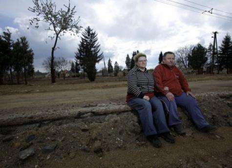 Pal (right) and Piroska Nyoma sit where their house once stood in Devecser