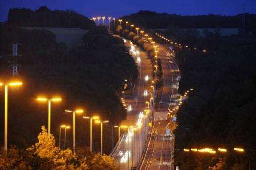 People drive on highway at nightfall in the south of Brussels, near Namur