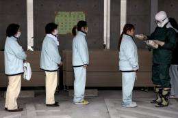People line up for radiation screening at Koryama in Fukushima prefecture in March