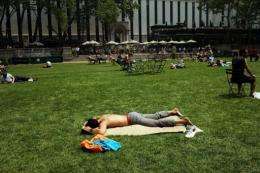 People sunbathe in Bryant Park during a heat wave