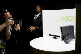 Photographers take pictures of the Kinect peripheral and the Xbox 360 console