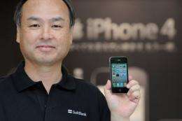President of mobile phone carrier Softbank, Masayoshi Son displays a iPhone 4
