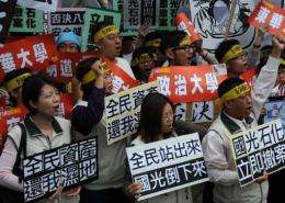 Protesters from central Changhua county display anti-Kuokuang Petrochemical Technology Co, flags
