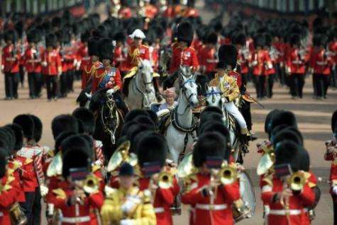 Queen Elizabeth II (C) and her husband Prince Phillip, The Duke of Edinburgh ride to Buckingham Palace
