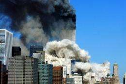 Smoke billows up after the first of the two towers of the World Trade Center collapses