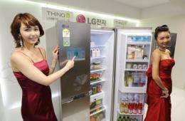 South Korean models pose with an LG "smart fridge" in Seoul