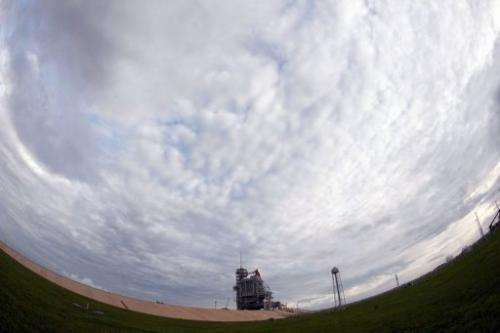 Storm clouds move into the area as Space Shuttle Atlantis sits on Launch Pad 39A