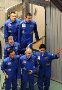 The Mars 500 volunteer crew members smile for the press before being locked into the isolation facility