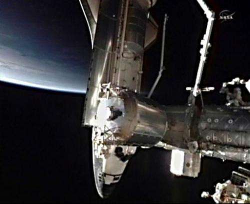 This July 10 NASA TV video image shows the space shuttle Atlantis docking with the International Space Station (ISS)