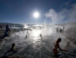 Tourists bathe in hot springs near Agua Brava, 4000 meters above sea level, in the Uyuni salt flats, Potosi, Bolivia