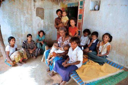 Vadthya Sukhya and Vadthya Achi with their eleven children in front of their home in Nalgonda District near Hyderabad