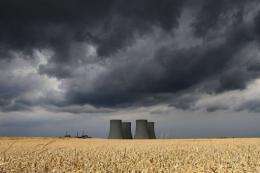 View of the four cooling towers of Temelin Nuclear Power Plant behind a grain field in the village of Temelin