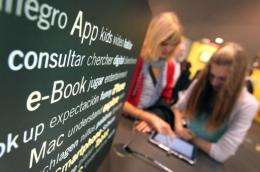 Visitors try out ebook devices at the Frankfurt Book Fair in Germany