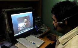 Volunteer mentor Santosh Kumar (R), conducts an online class from New Delhi for students in a remote village in Bihar