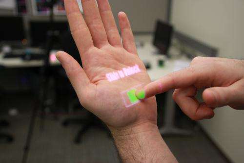 Wearable depth-sensing projection system makes any surface capable of multitouch interaction