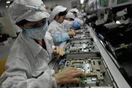 Workers assemble electronic components at Foxconn's factory in Shenzhen in 2010