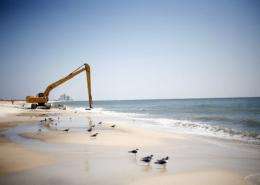 Workers clean oil leftover from the Deepwater Horizon oil spill in the Gulf of Mexico