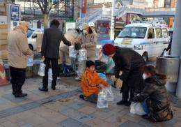 Workers from Koriyama distribute emergency waterbags to citizens in downtown Koriyama