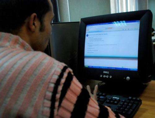 An Egyptian man tries to access a website at an internet cafe