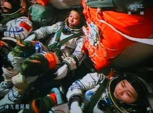 Chinese astronauts Liu Wang (centre), Jing Haipeng (left) and Liu Yang in the Shenzhou-9 spacecraft