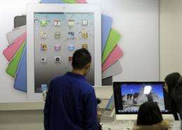 Customers browse products at an Apple store in Beijing