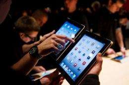 Journalists test the new iPad following a live stream of its US launch, at an event in London on March 7