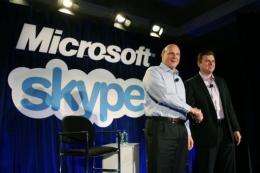 Microsoft CEO Steve Ballmer (L) shakes hands with Skype CEO Tony Bates