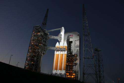 Mighty Delta 4 heavy rocket and Clandestine satellite poised at pad