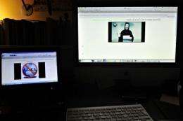 Monitors display the hacked Greek ministry of justice website on February 3