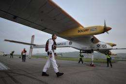 Pilot Andre Borschberg walks to the Swiss sun-powered aircraft Solar Impulse before takeoff in Payerne