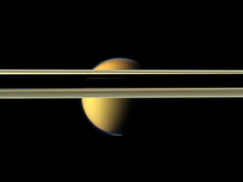 Saturn and its largest moon reflect their true colors