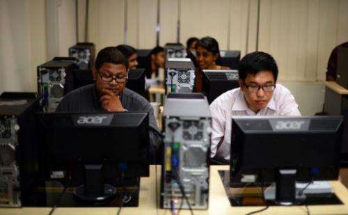 Students prepare for an exam in front of their computers at Kuala Lumpur-based Asia e University