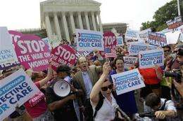 US high court upholds heart of Obama health law