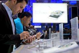Visitors try out the smaller tablet Galaxy Note II