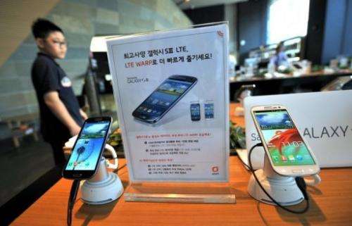 A man walks past a display of Samsung's Galaxy S3 at a mobile phone shop in Seoul in August 2012