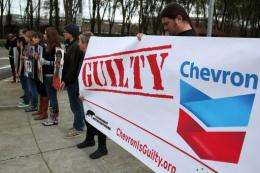 Protestors hold signs during a demonstration outside of the Chevron headquarters in 2011