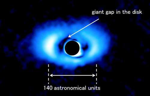 Discovery of a giant gap in the disk of a sun-like star may indicate multiple planets