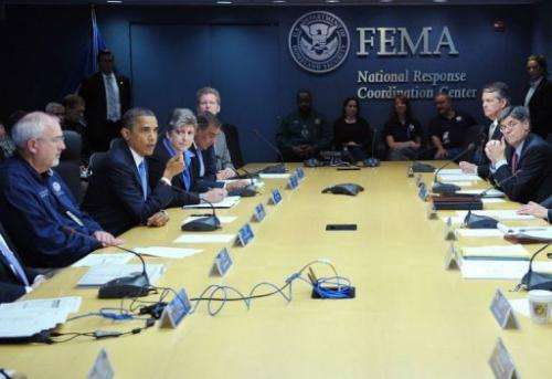 US President Barack Obama (L) takes part in a meeting at FEMA headquarters