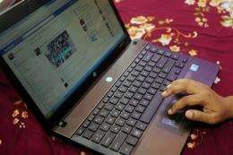 A Bangladeshi woman logs onto social networking website Facebook on her laptop in Dhaka in May
