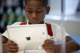 A Brazilian boy looks at an iPad