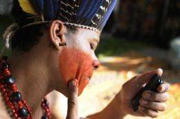 A Brazilian Indian makes up before the inauguration of the People's Summit