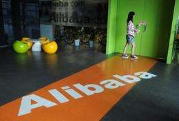 A Chinese Alibaba employee walks through a communal space at the company headquarters